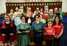 Singers warm up for carols